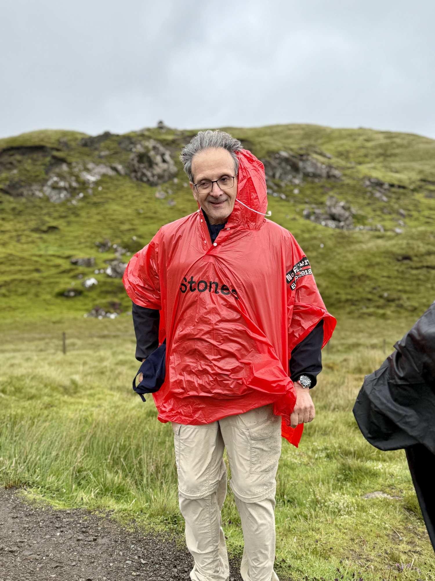guest wearing poncho hiking old man of storr Isle of Skye